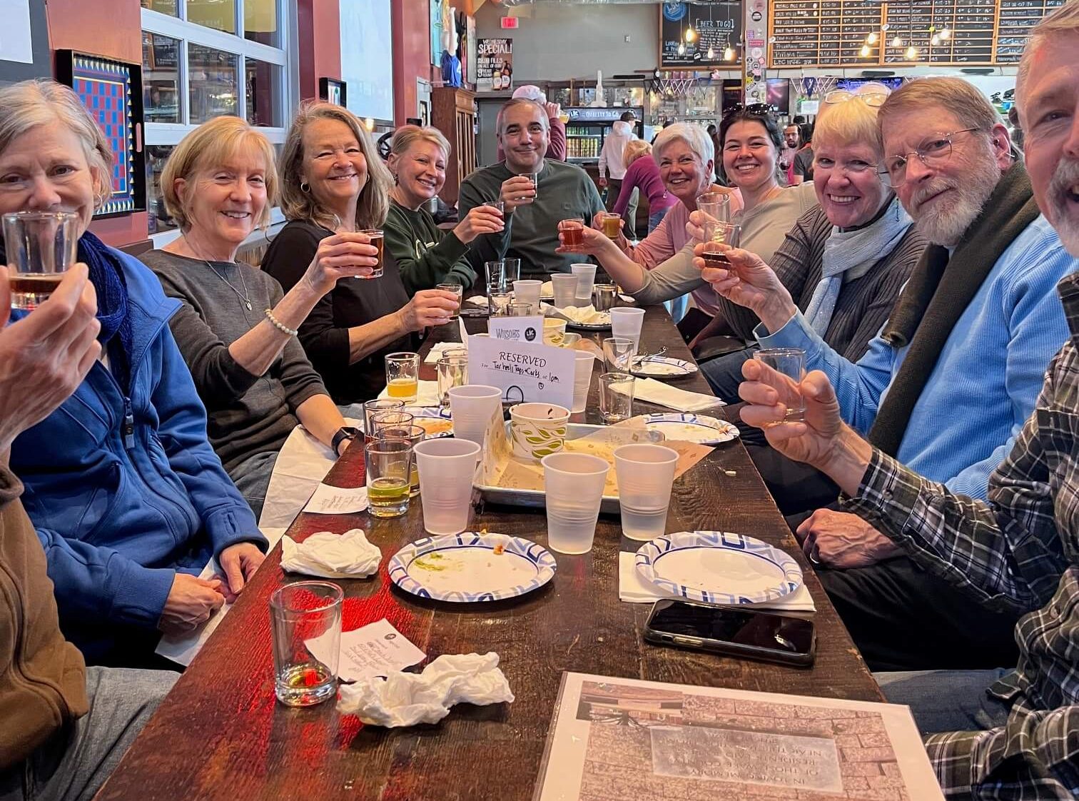 People raising a glass around table at Lynnwood